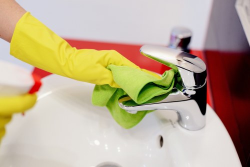 Professional office cleaner maintaining a workspace in NW5