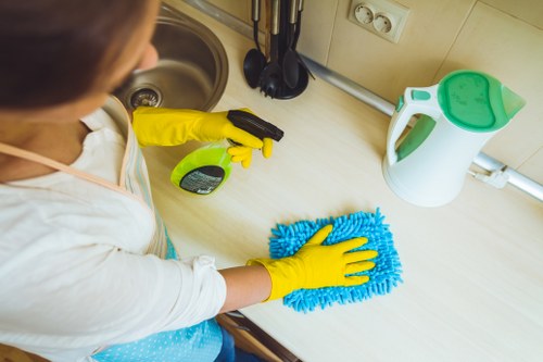 A cleaner restoring a built-in oven in a NW5 property